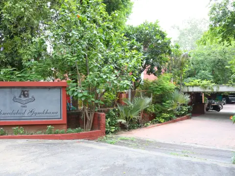 Ahmedabad Gymkhana entrance sign and tree-lined driveway