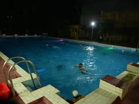 Outdoor swimming pool at Bokaro Club at night