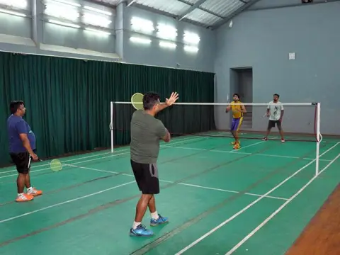 Indoor badminton court in use at Cuttack Club