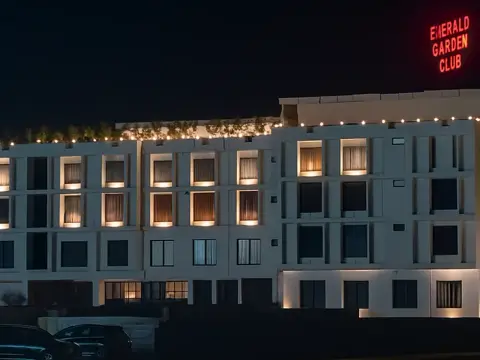 Emerald Garden Club signed exterior at night