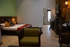 Kodaikanal Club — guest suite seating and bedroom