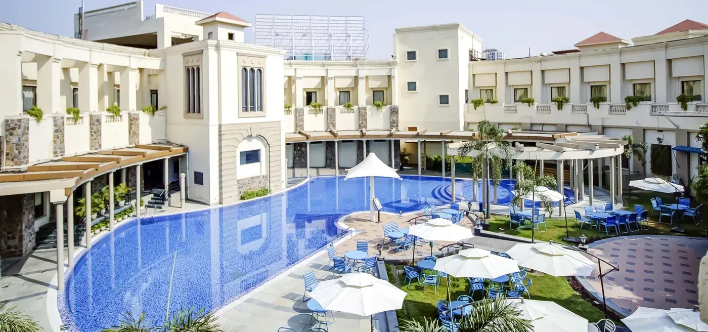 Swimming pool and clubhouse courtyard — The Stellar Gymkhana
